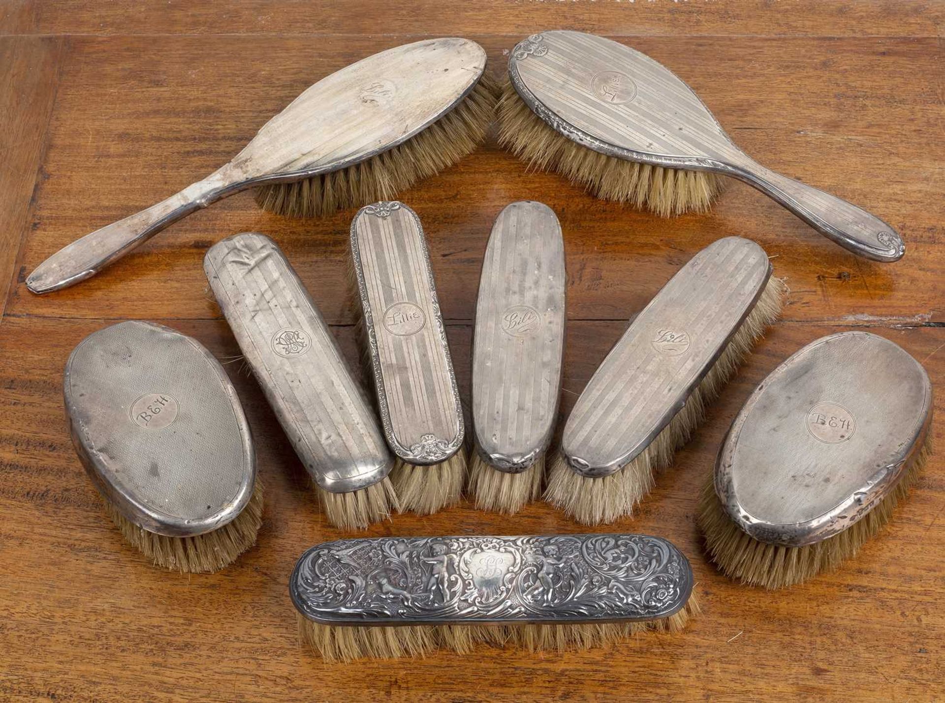 Nine silver-backed hairbrushes Worn and with bumps