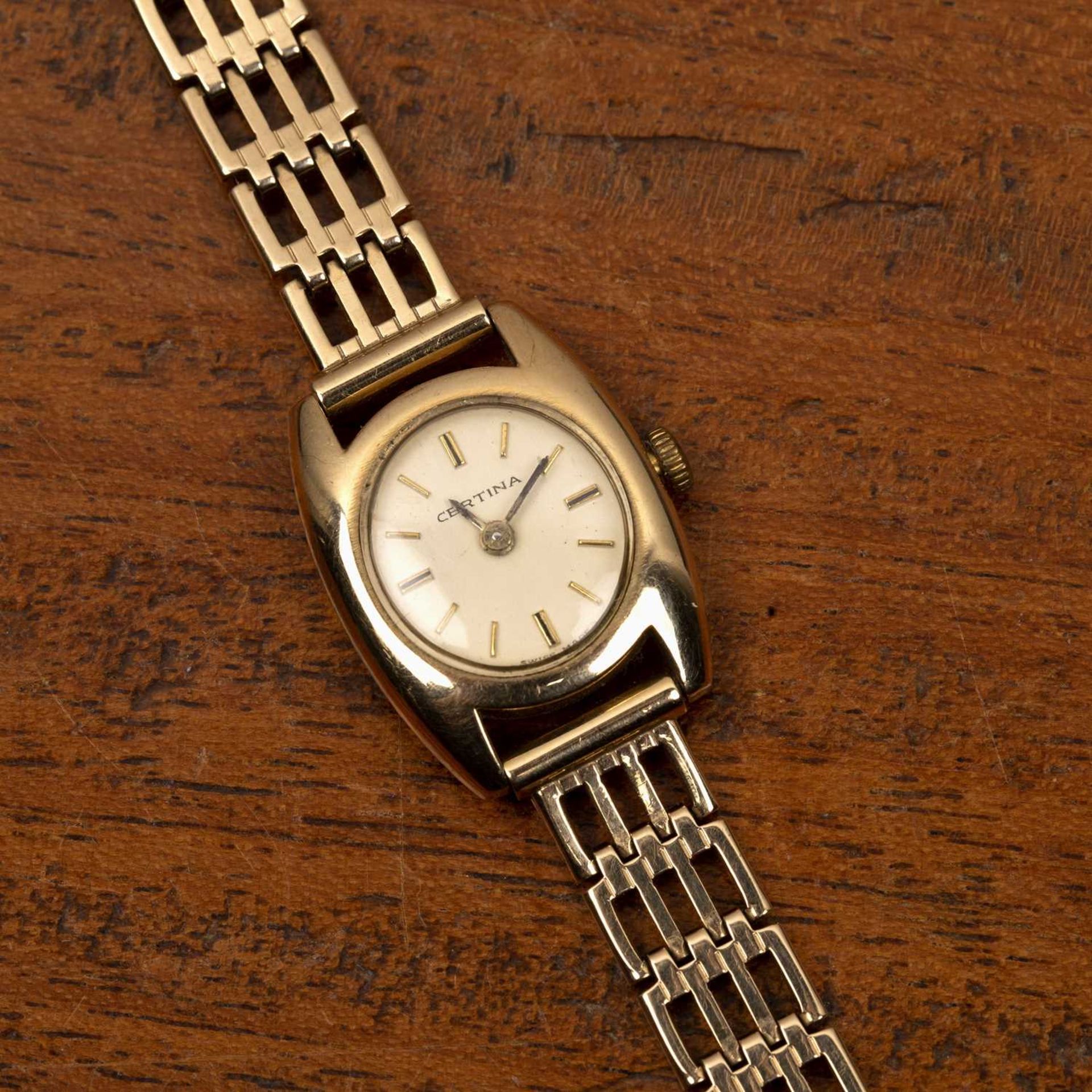 A lady's 9ct gold bracelet watch by Certina the oval dial with baton markers, on bracelet strap, the