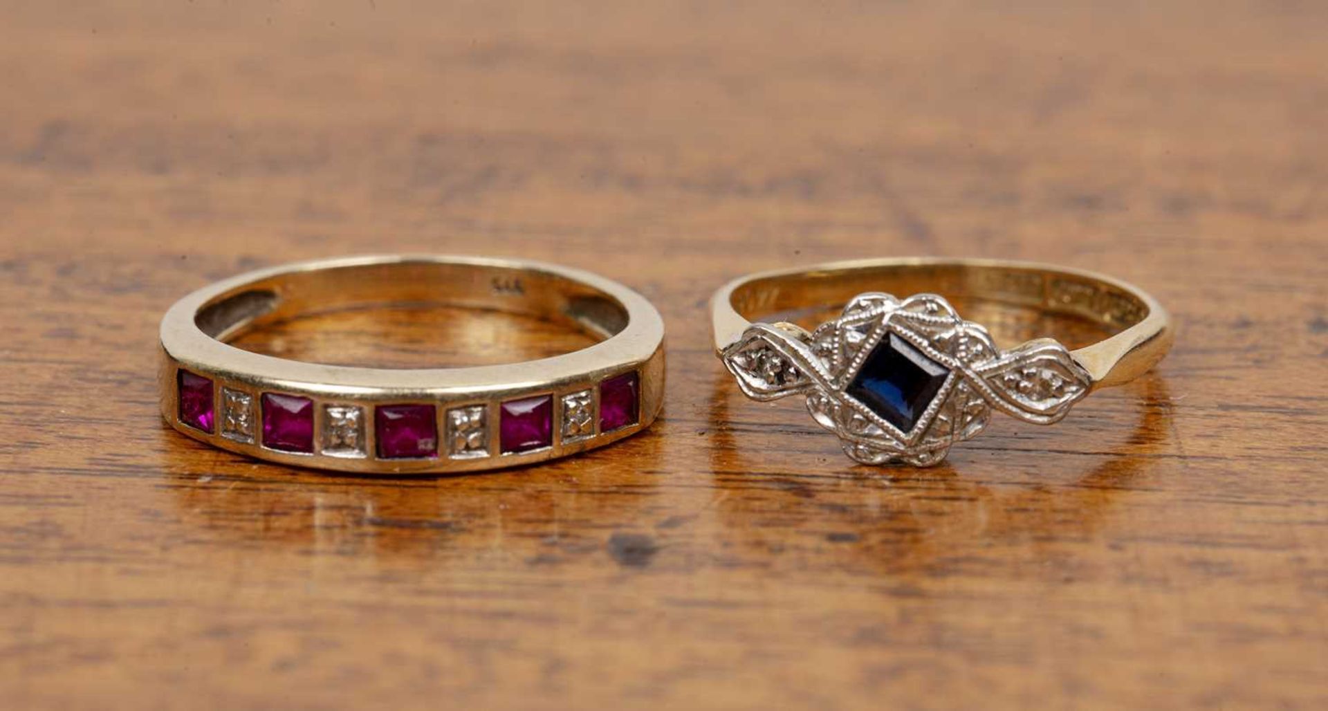 Two rings the first an 18ct yellow gold and platinum example, with diamond chips and a blue