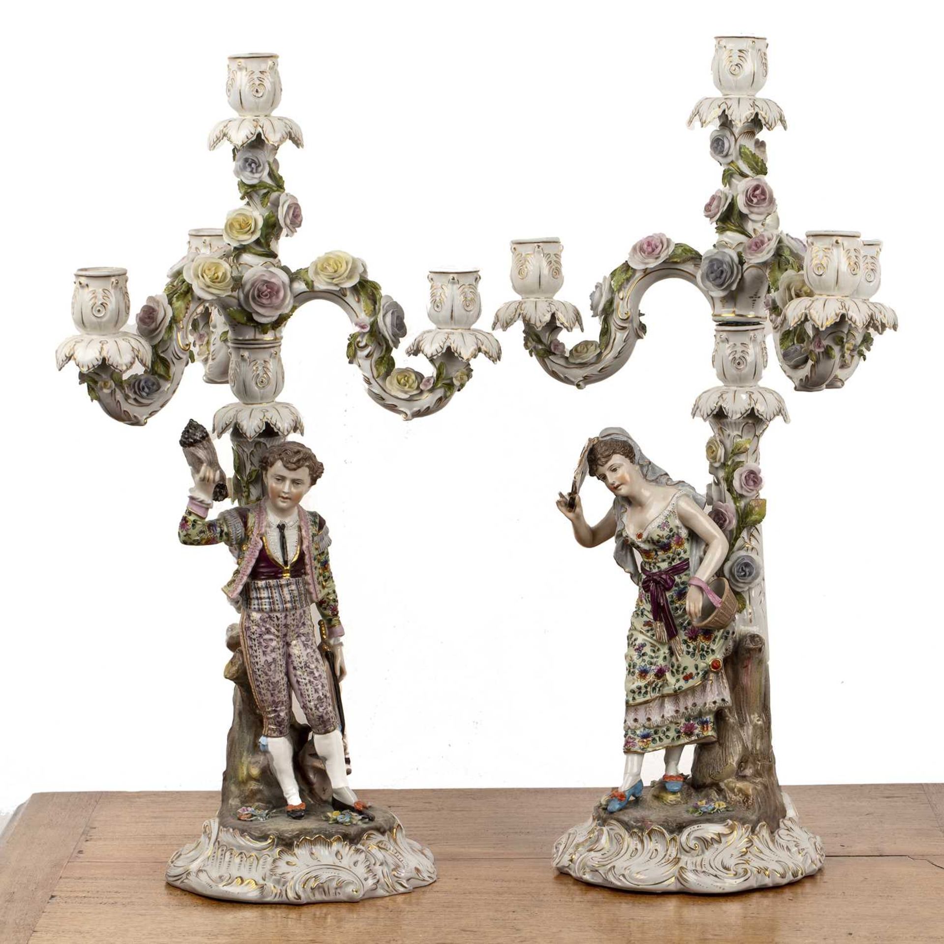 Pair of Triebner, ENS & Eckert (Volkstedt) porcelain candlesticks with figural decoration, flowers