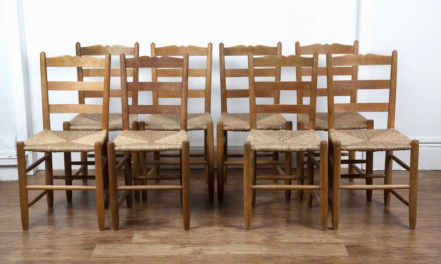 Gordon Russell (1892-1980) Set of eight ash ladderback chairs with rush seats, and turned