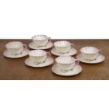 Set of six Belleek shell cups and saucers porcelain, with pink highlighted decoration, black marks