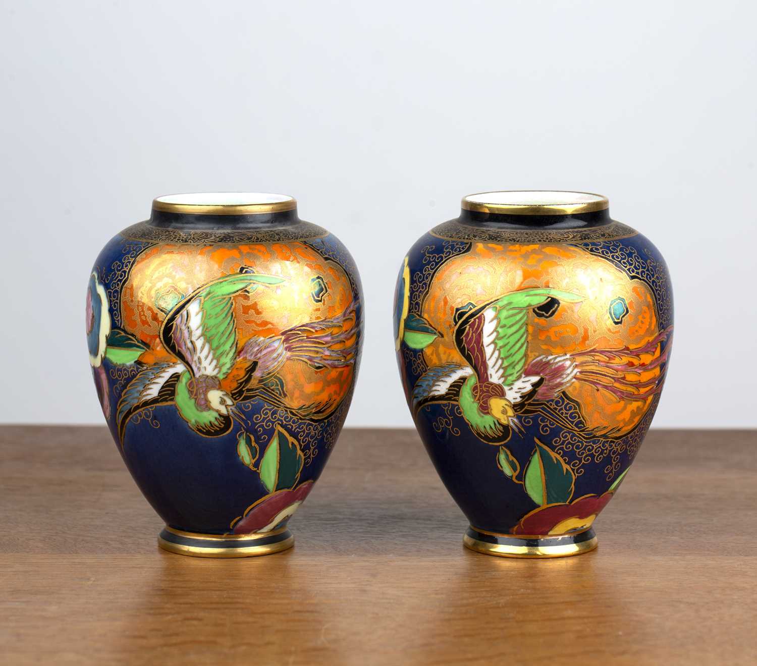 Pair of Carltonware vases with Art Deco bird decoration on blue ground, transfer marks to the