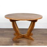Cotswold School (In the Barnsley style) Oak, low table with a circular top on quadrapartite base,