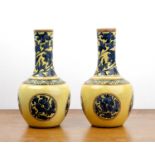 Pair of Mintons pottery vases with blue foliate designs on yellow ground, decorated in the Chinese