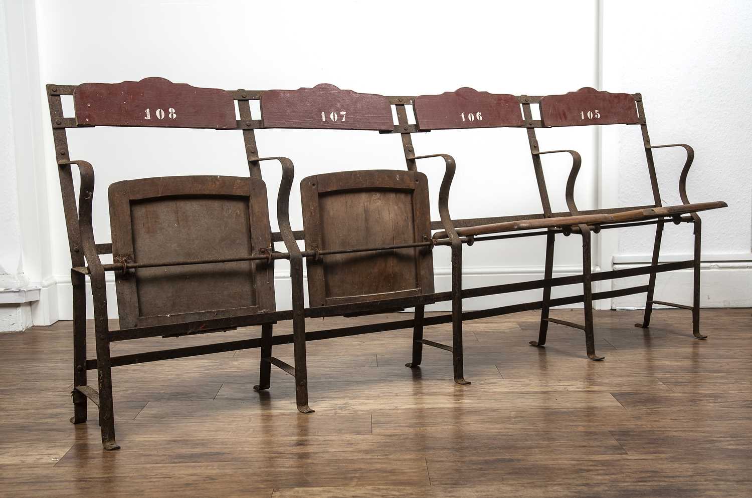 Vintage theatre chairs comprising of four joined seats, painted wood on wrought metal base, the back