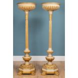 A pair of large painted and giltwood uplighters
