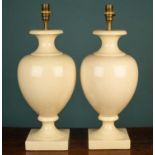 A pair of cream crackle baluster shaped table lamps