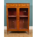 A George III Sheraton style satinwood library cabinet