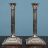 A pair of antique silver plated candle sticks