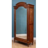 A late 19th or early 20th century walnut armoire in the neoclassical style