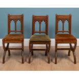 A set of three Victorian oak chorister's chairs