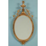 A Neoclassical style oval wall mirror