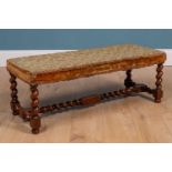 A 17th century style walnut rectangular stool with upholstered seat