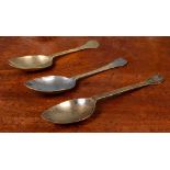 A group of three antique brass or latten spoons