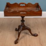 An occasional table with a galleried rectangular tray-top and pierced carrying handles