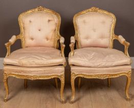 A pair of antique 18th century style carved gilt wood and gesso moulded salon chairs