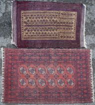 A modern machine made Baluchi rug together with a handwoven Afghan style prayer rug