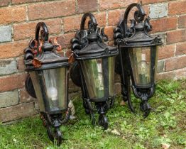 Three wall mounted metal lanterns