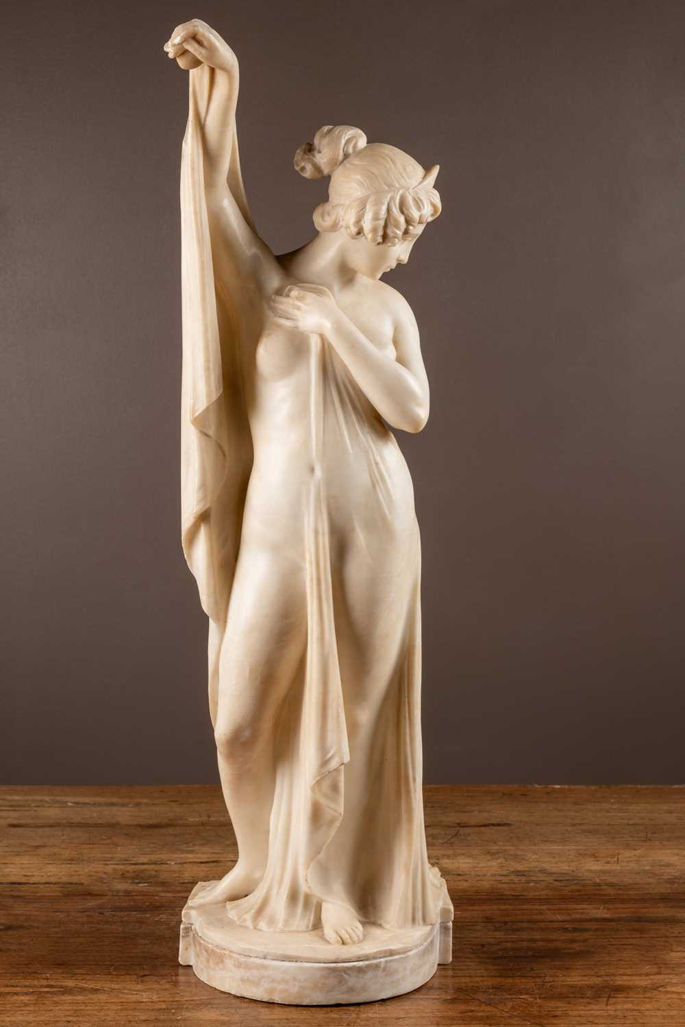 An alabaster sculpture of a draped nude