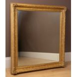 A gilt framed mirror with foliate decoration