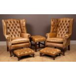 A pair of Regency style leather wingback armchairs together with three stools