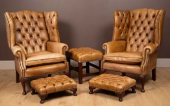 A pair of Regency style leather wingback armchairs together with three stools