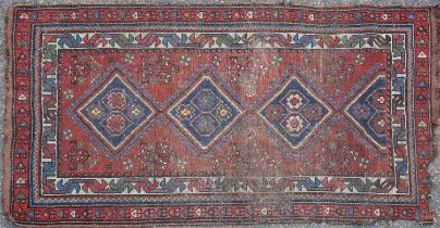 An early-20th century hand knotted Kazak style rug