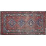 An early-20th century hand knotted Kazak style rug