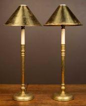 A pair of French brass table lamps with brass shades