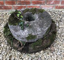 A grain grinding stone quern