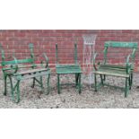 A wirework plant stand and three green garden chairs