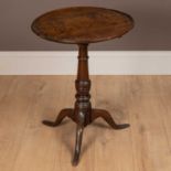 An 18th century oak circular top tripod table