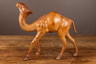 A 20th century liberty leather model of a camel with green glass eyes 44cm high Qty: 1 Damage to the