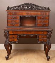 An Irish style mahogany writing desk with a superstucture, the galleried top of pierced carved