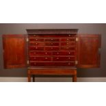 A mahogany collectors cabinet on stand