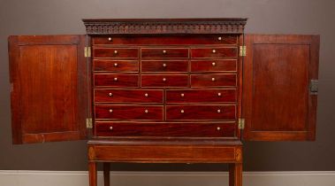 A mahogany collectors cabinet on stand