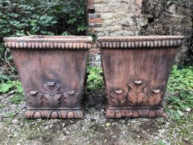 A pair of cast terracotta coloured garden planters