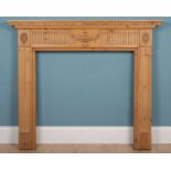 A pine fire surround carved in the Adams style