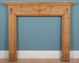 A pine fire surround carved in the Adams style
