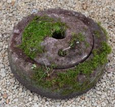 A carved stone grinding quern
