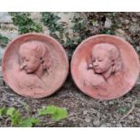 Two terracotta roundels