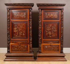 A pair of 20th-century Chinese hardwood panel inset pedestal cupboards
