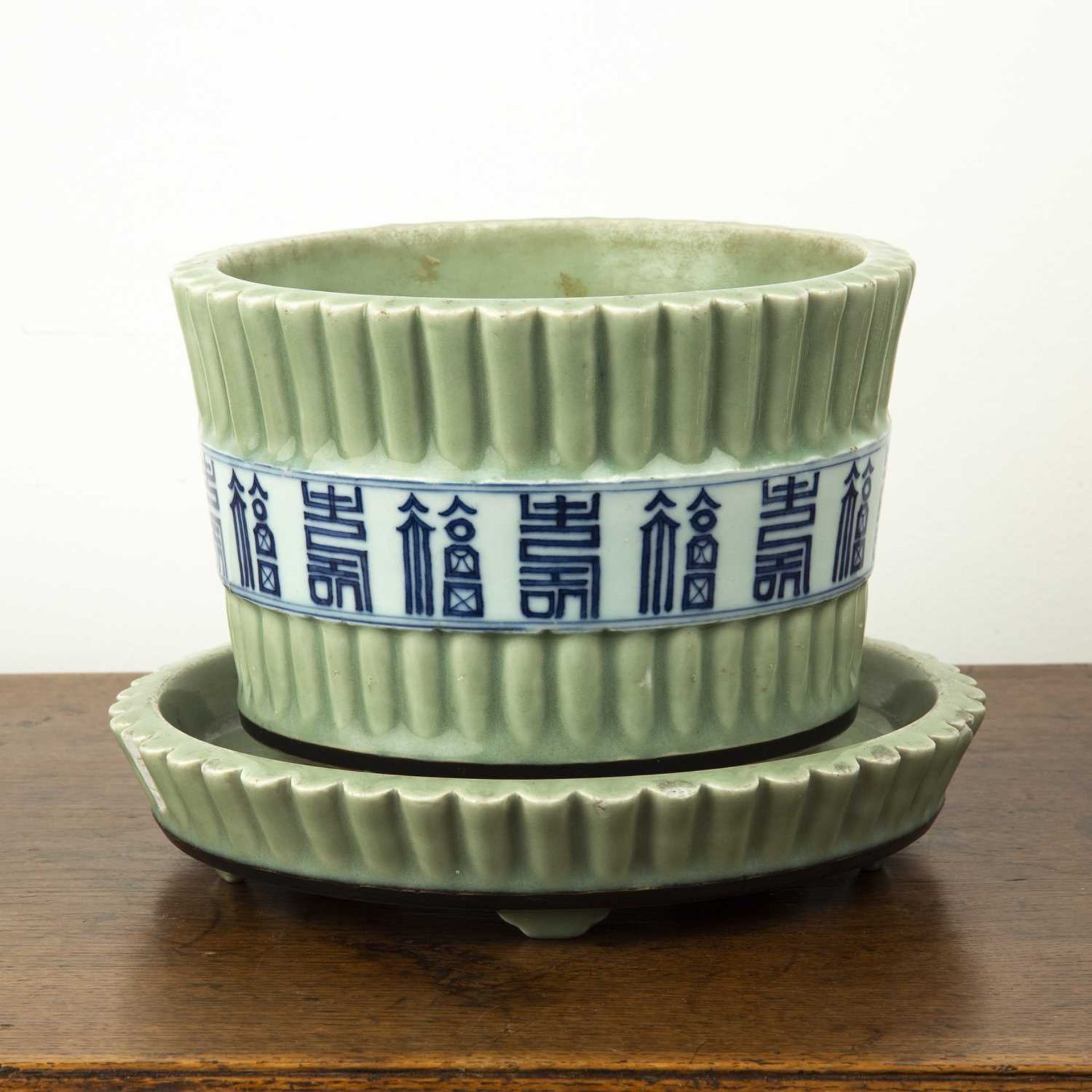 Celadon jardiniere and stand Chinese, 19th Century painted with a band around the centre with blue