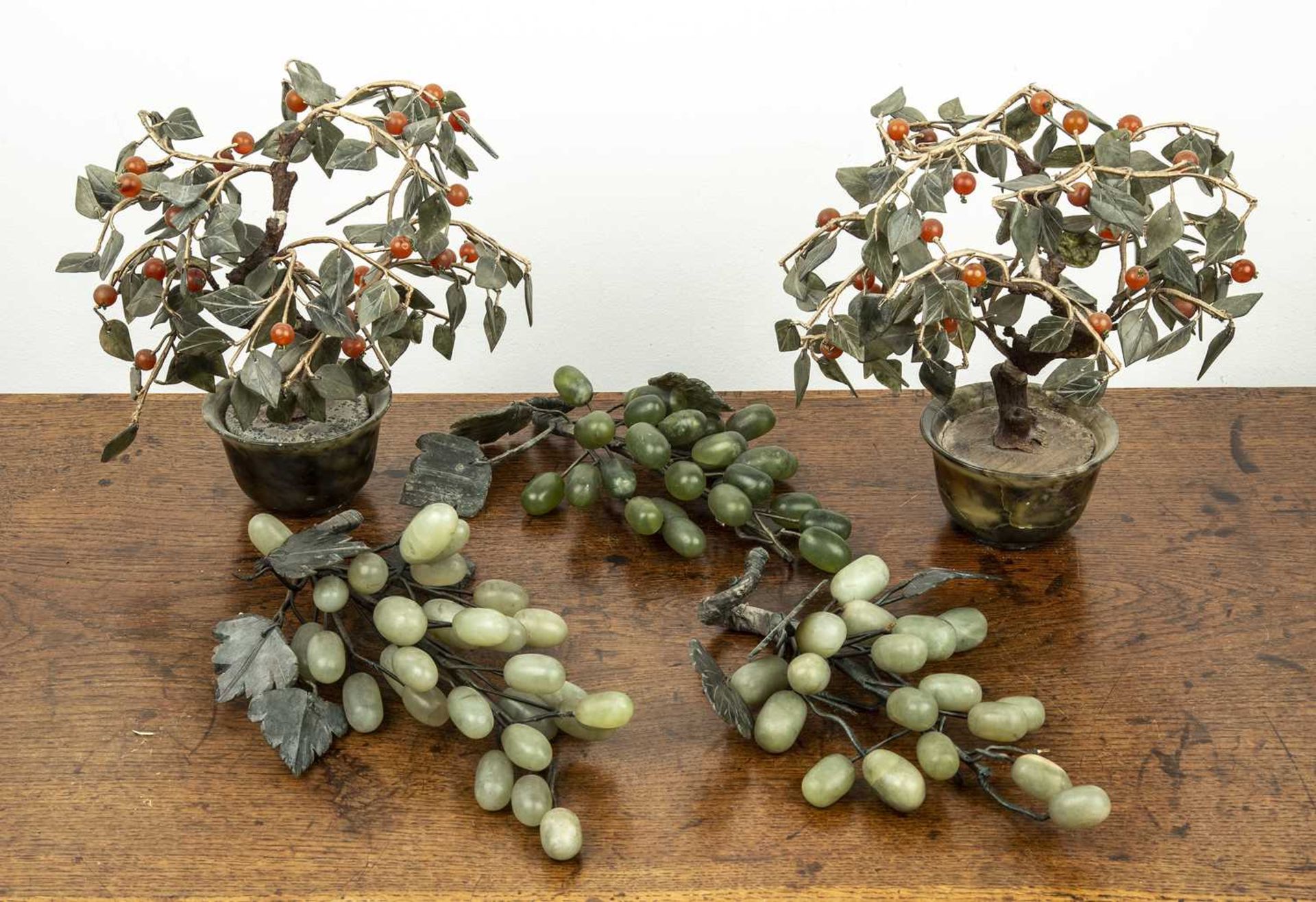 Pair of hardstone model miniature trees Chinese each with a bowenite jardiniere, approx 20cm high,