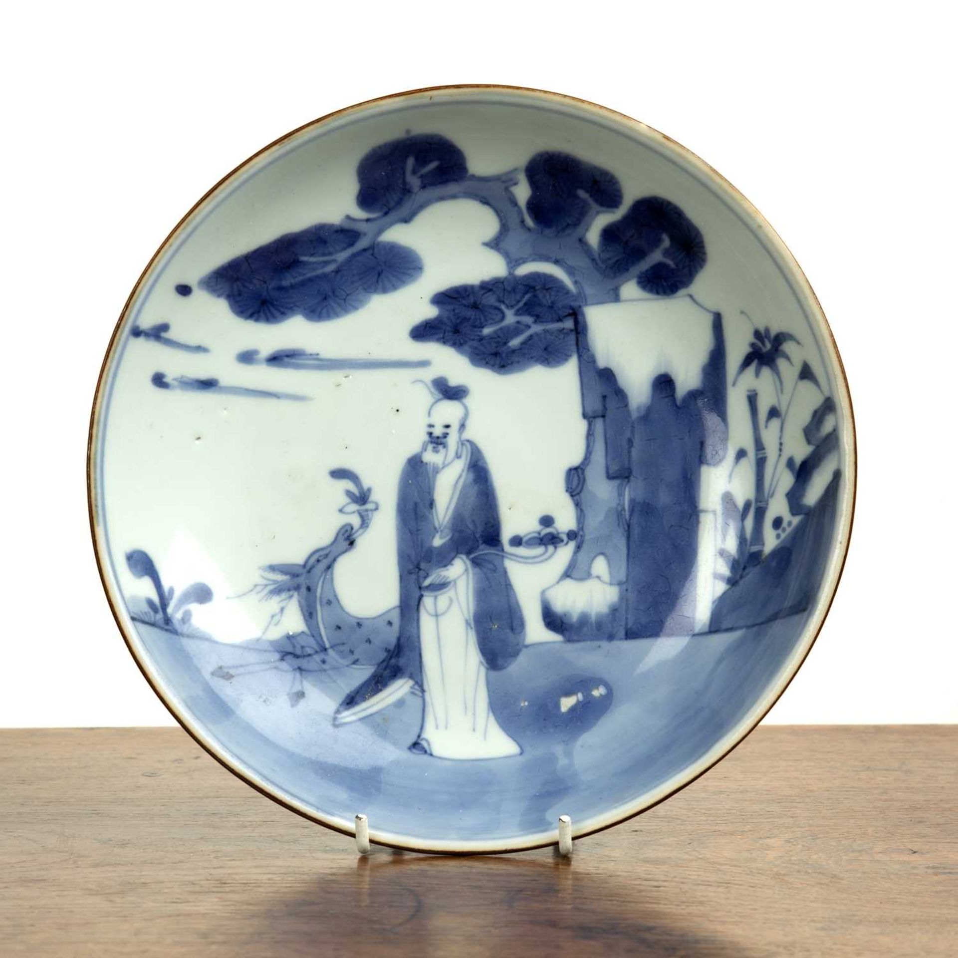 Blue and white porcelain shallow dish Chinese, 18th Century painted with a Lohan holding a ruyi