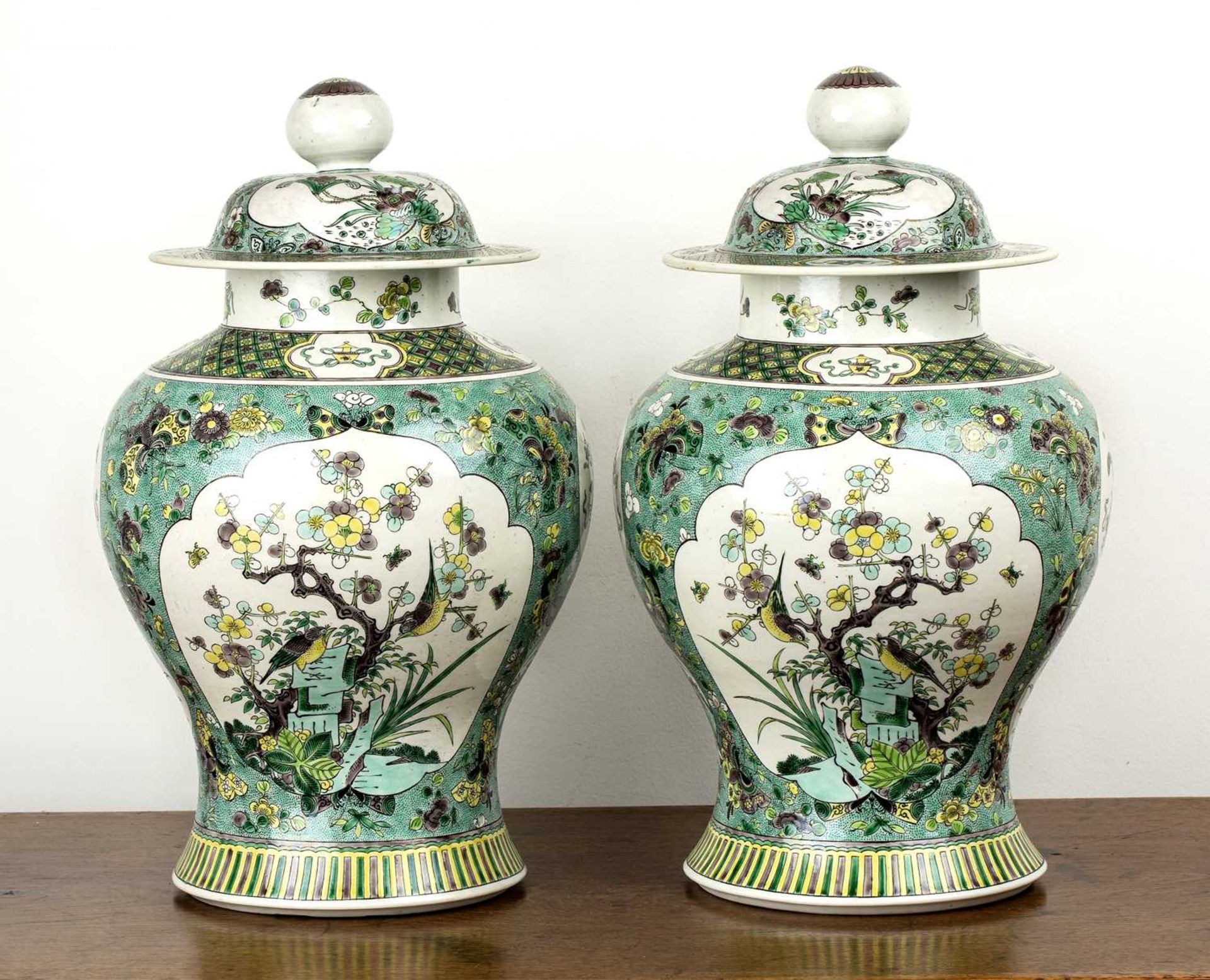 Pair of biscuit baluster vases and covers Chinese, 19th Century each painted in green enamels with