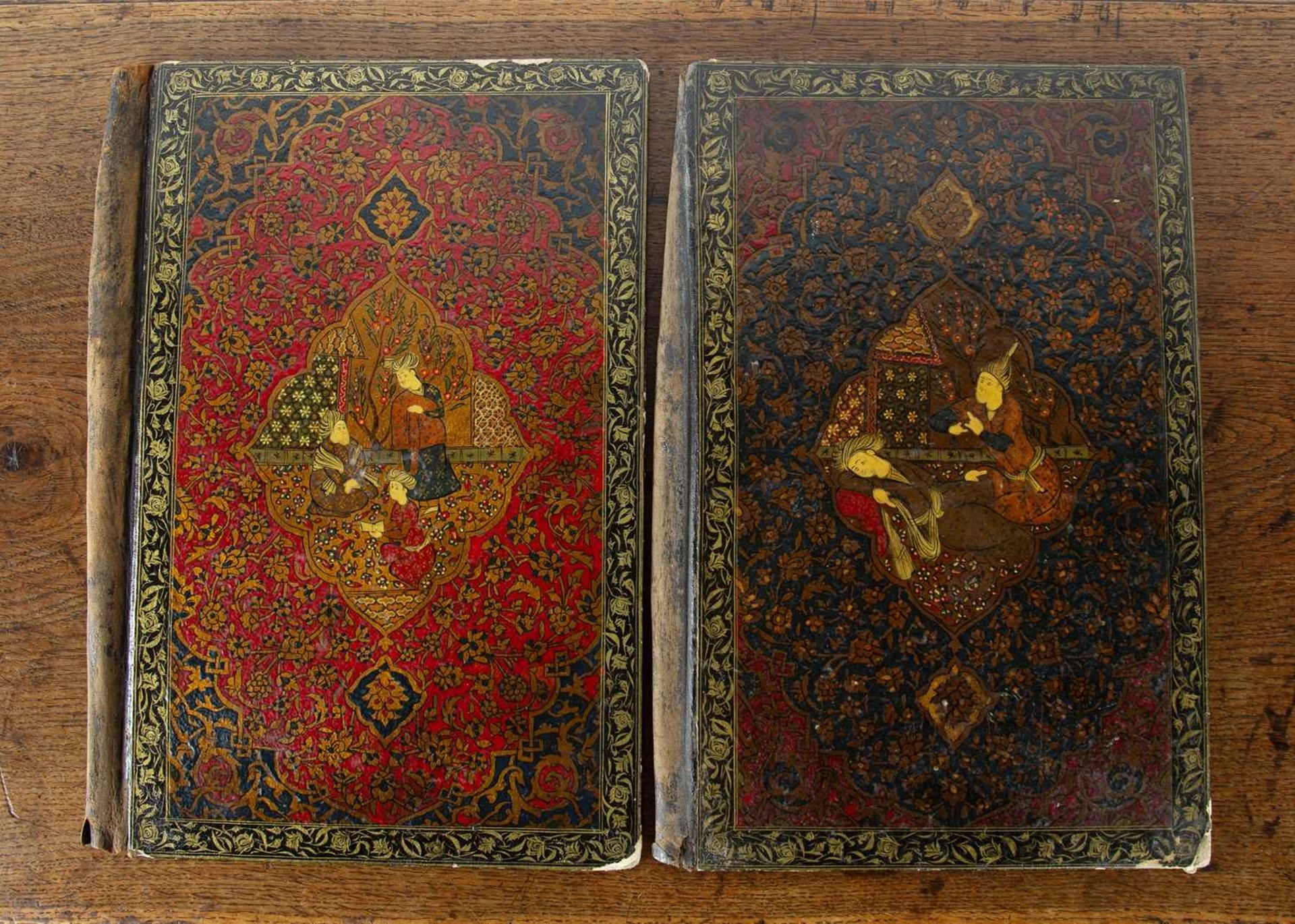 Pair of Persian book covers Iran each painted with a panel of figures, within an allover foliate