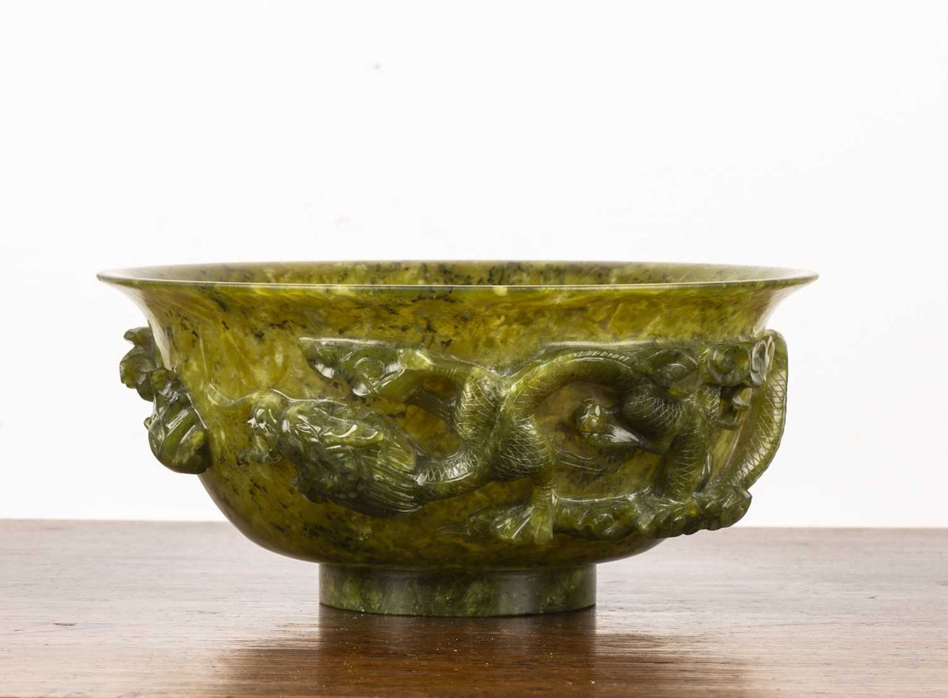 Bowenite bowl Chinese, 20th Century having a carved raised band of a phoenix, dragon, and a