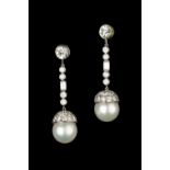 A pair of cultured pearl and diamond ear pendant drops, each with a cultured pearl surmounted by a